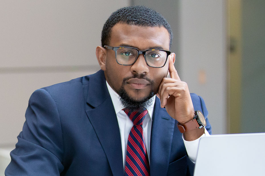 Attorney headshot in Raleigh office environment with natural background and professional look