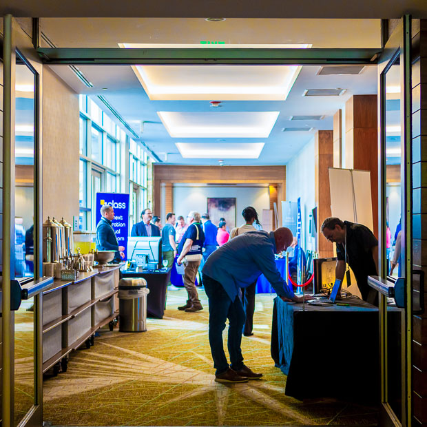 Wide view of trade show floor with booths and attendees in Raleigh NC