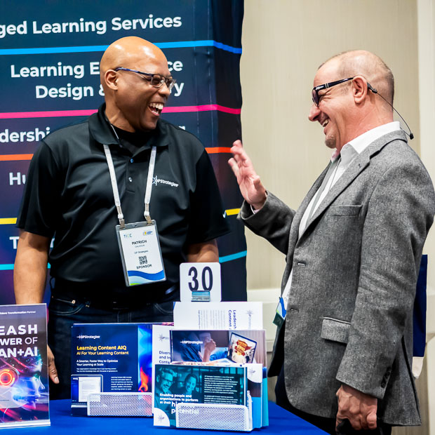 Attendees interacting with exhibitors at trade show in Raleigh NC